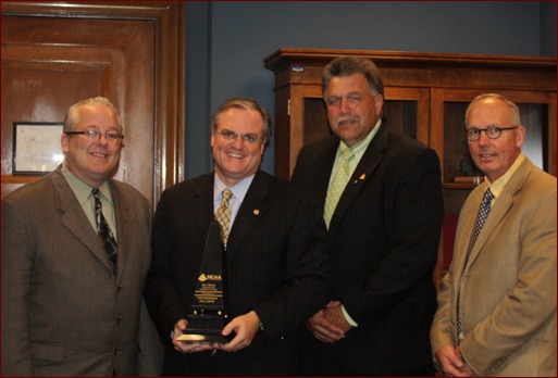 Congressman Heath Shuler accepts the Freedom and Prosperity Award. Shown are Jeff Buczkiewicz, Moroni Mejia, Paul Oldham (rear), Calvin Brodie, Heath Shuler, and Sue and Paul Odom
