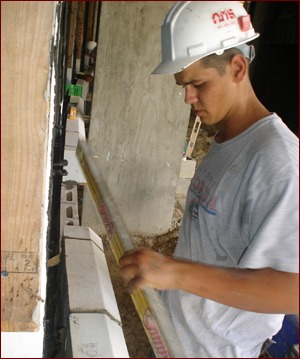 Prescott cut and installed the stone on a large radius wall that required considerable plumb and level work. Note the laser in the background.