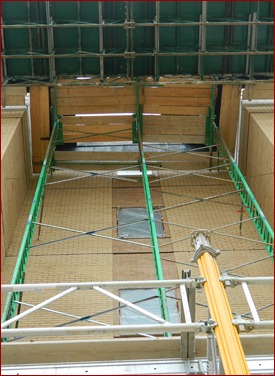 A Non-Stop “triple-tower” is used in conjunction with a mast-climber to lay the inset on this brick veneer building.