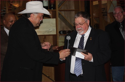 Jerry Painter accepts the Masonry Hall of Fame award from Mackie Bounds.