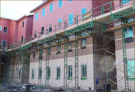 Photo 5: Guardrails are installed on the ground and stay in place as the wall is built. No one ever leaves the “safety zone” on adjustable scaffolding.