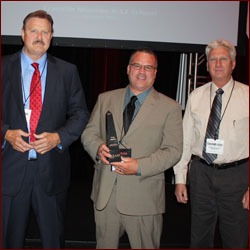 Linn Thomas (left), Tectonic Systems, and Michael Homan (right), Wayne Builders Supply, accept Education 9-12 category award with a colleague. 