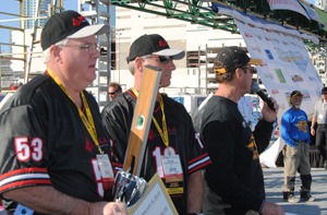 MCAA Chairman John Smith Jr. and Vice-Chairman Mark Kemp prepare to award a Fastest Trowel on the Block winner.