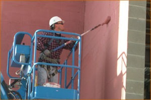 Tim Crookshanks, Western Waterproofing, rolls on a water-based, fluid-applied air barrier at the new H & R Block Building in Kansas City, Mo. Photo courtesy of PROSOCO