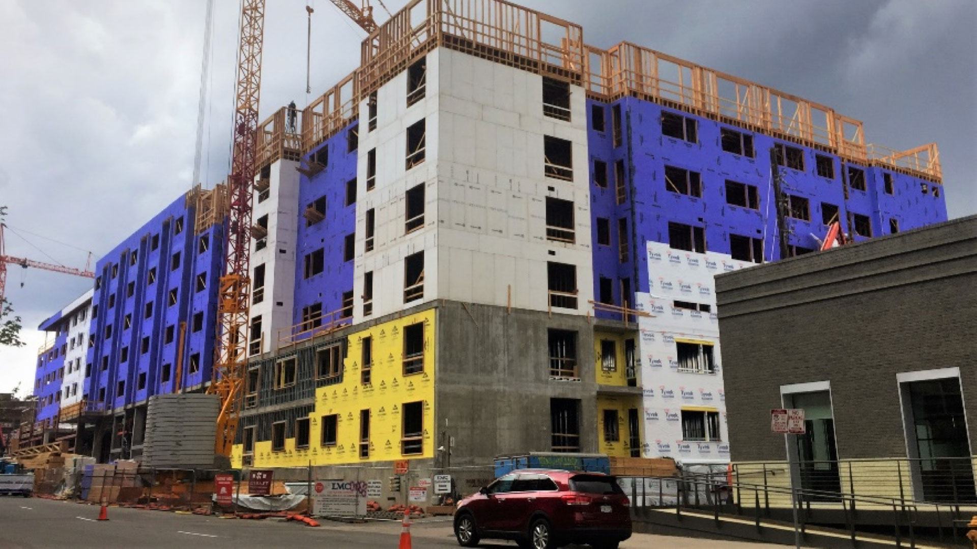 Podium-style building: 2 stories reinforced concrete and steel construction, with 5 stories wood framing above – all to be clad in masonry veneer. Podium-style building: 2 stories reinforced concrete and steel construction, with 5 stories wood framing above – all to be clad in masonry veneer.