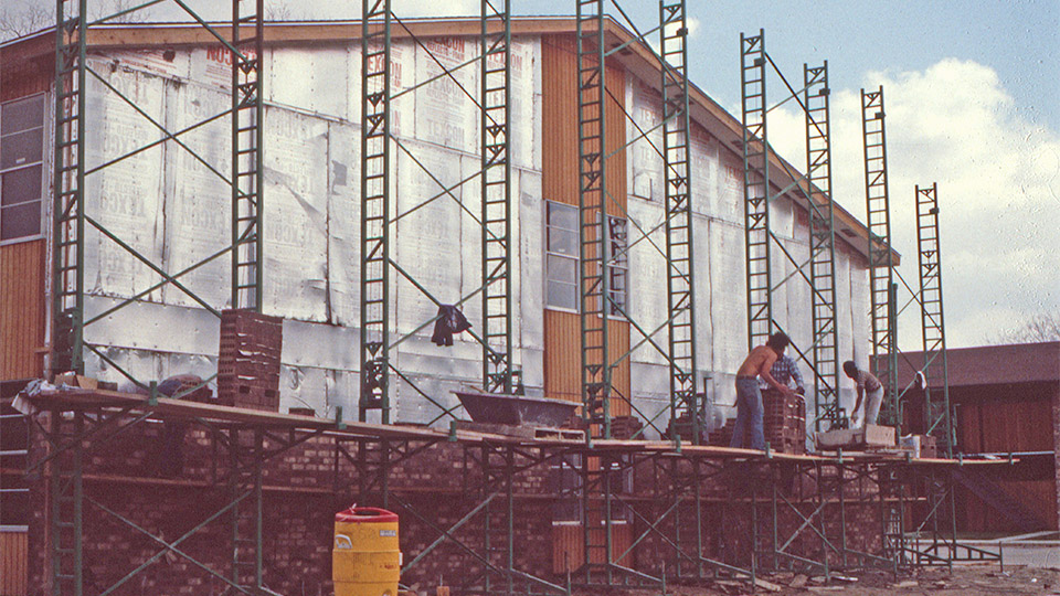 By the time this photo was taken in 1981, the Non-Stop Heavy-Duty scaffolding was gaining a foothold with contractors in seven states. Ignore the lack of guardrails, etc. — this was before OSHA had made their first inspection in many areas.