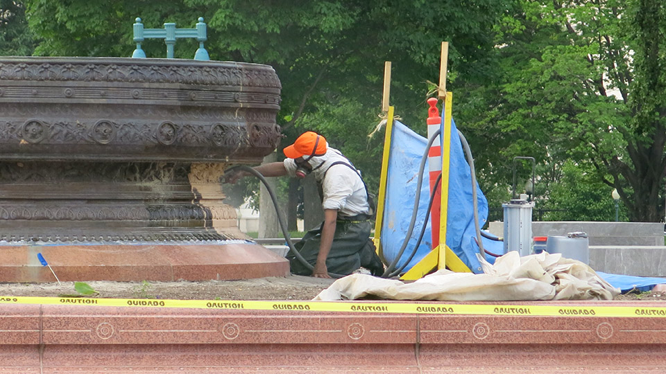 A bronze fountain on the East Plaza is cleaned and coated to restore the original brown statuary finish.