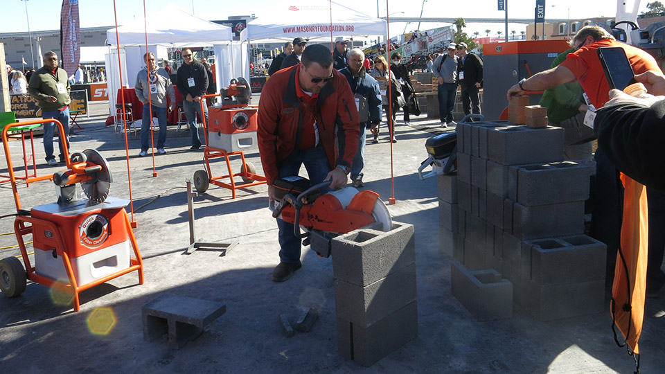 Franklin Wagner demonstrates a saw from IQ Power Tools that collects nearly 100% of the dust while it cuts.